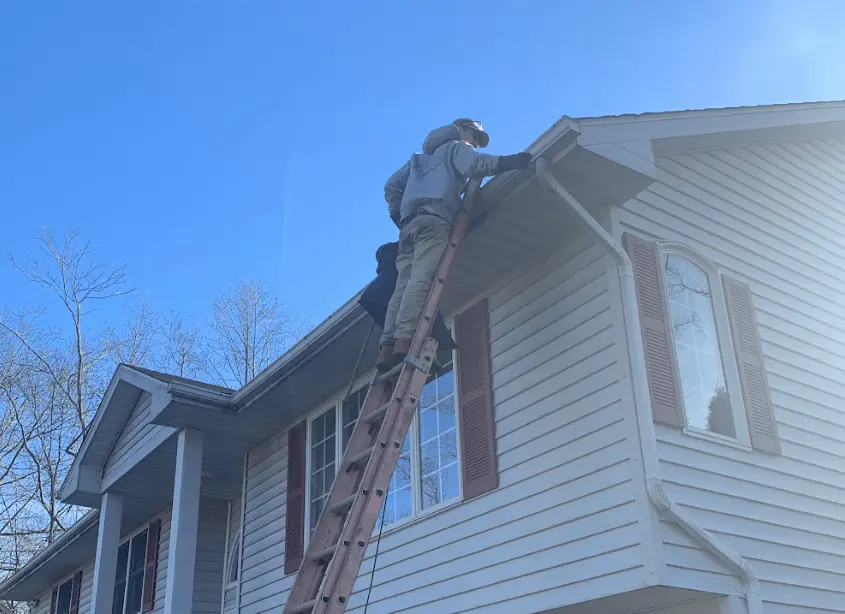 Gutter cleaning and maintenance being performed by Green Power Washing in Green